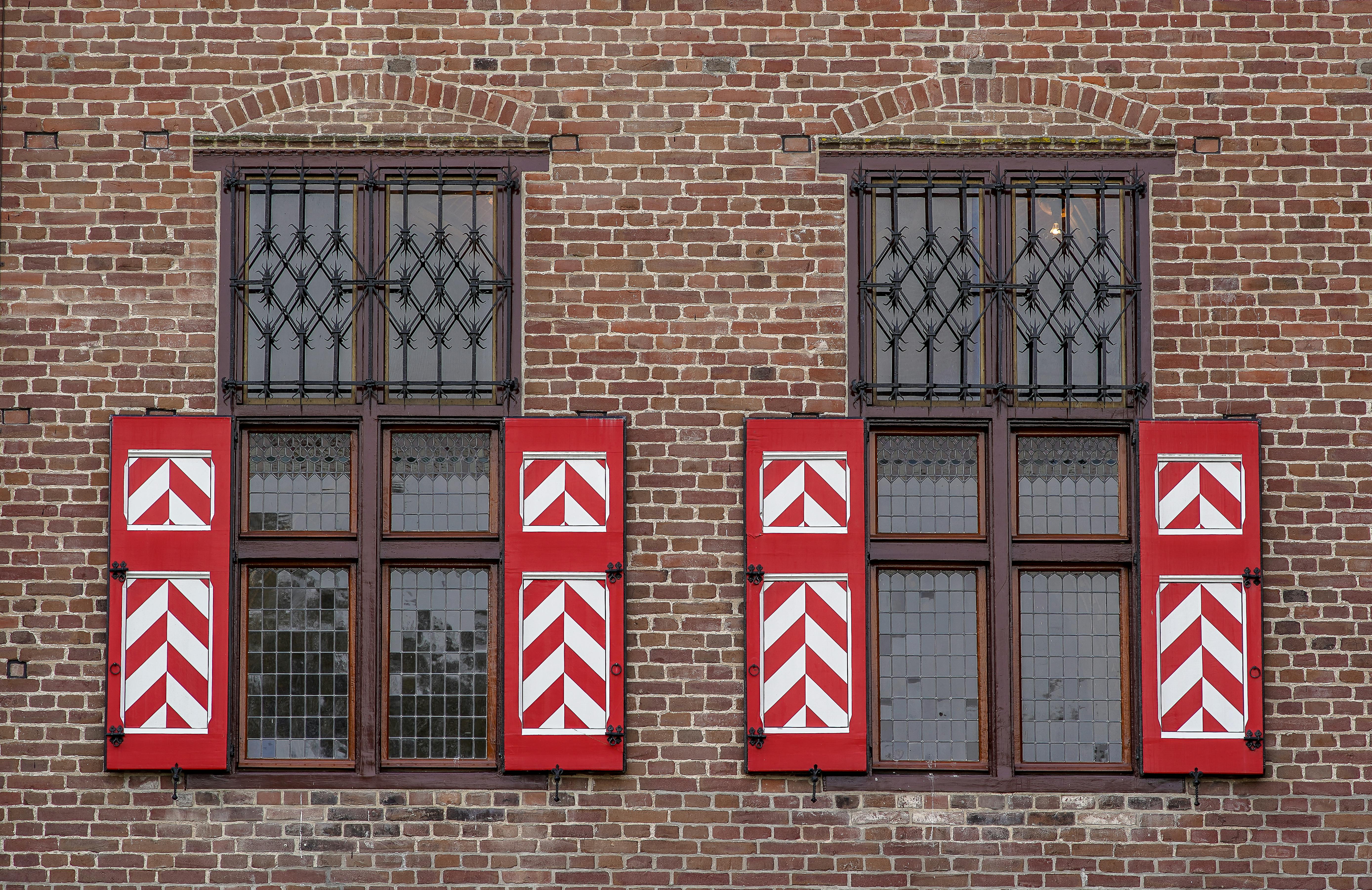 Wnętrze z panelami przesuwnymi zakrywającymi okno i szerokim zakładem na ścianę