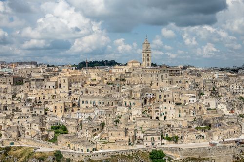 Free Stunning view of Matera's ancient cityscape with historic stone buildings under a cloudy sky. Stock Photo