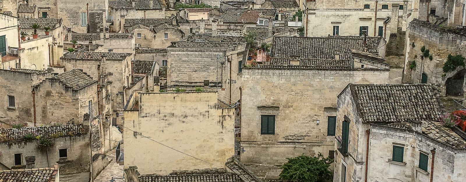 A picturesque view of the ancient stone architecture and rooftops of Matera, Italy.