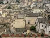 A picturesque view of the ancient stone architecture and rooftops of Matera, Italy.
