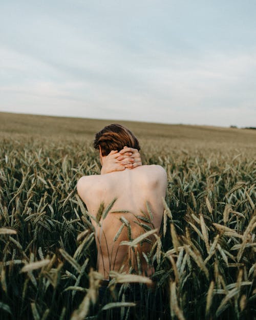 Man Standing on Green Grass Field