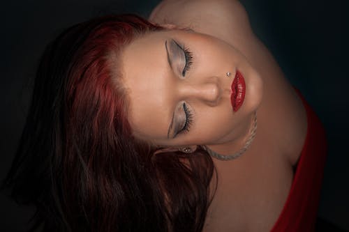 Woman With Red Hair Wearing Silver Necklace