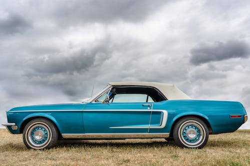Free Blue Convertible Car on Green Grass Field Under White Clouds Stock Photo