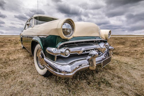 Close-up Shot of a Vintage Car on the Grassland During Gloomy Day