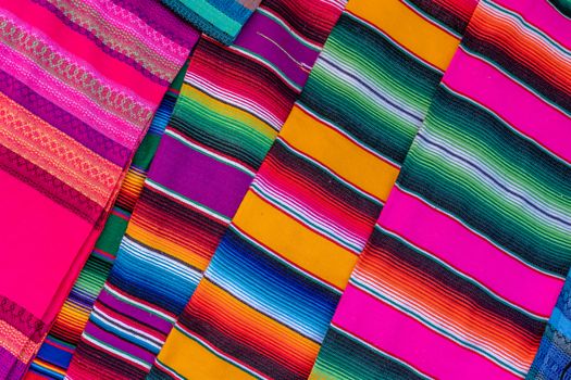 Colorful striped Mexican serape pattern displaying a vivid textile arrangement.