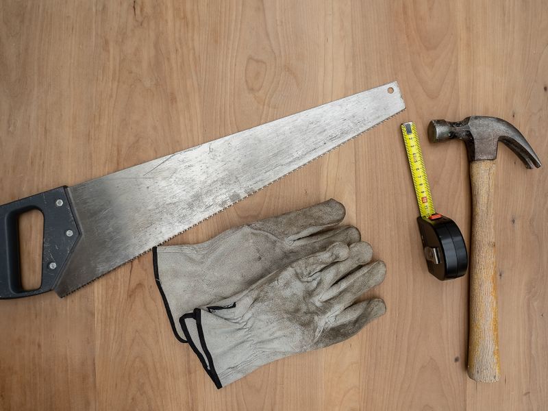 Carpentry hand tools laid out on a wooden surface