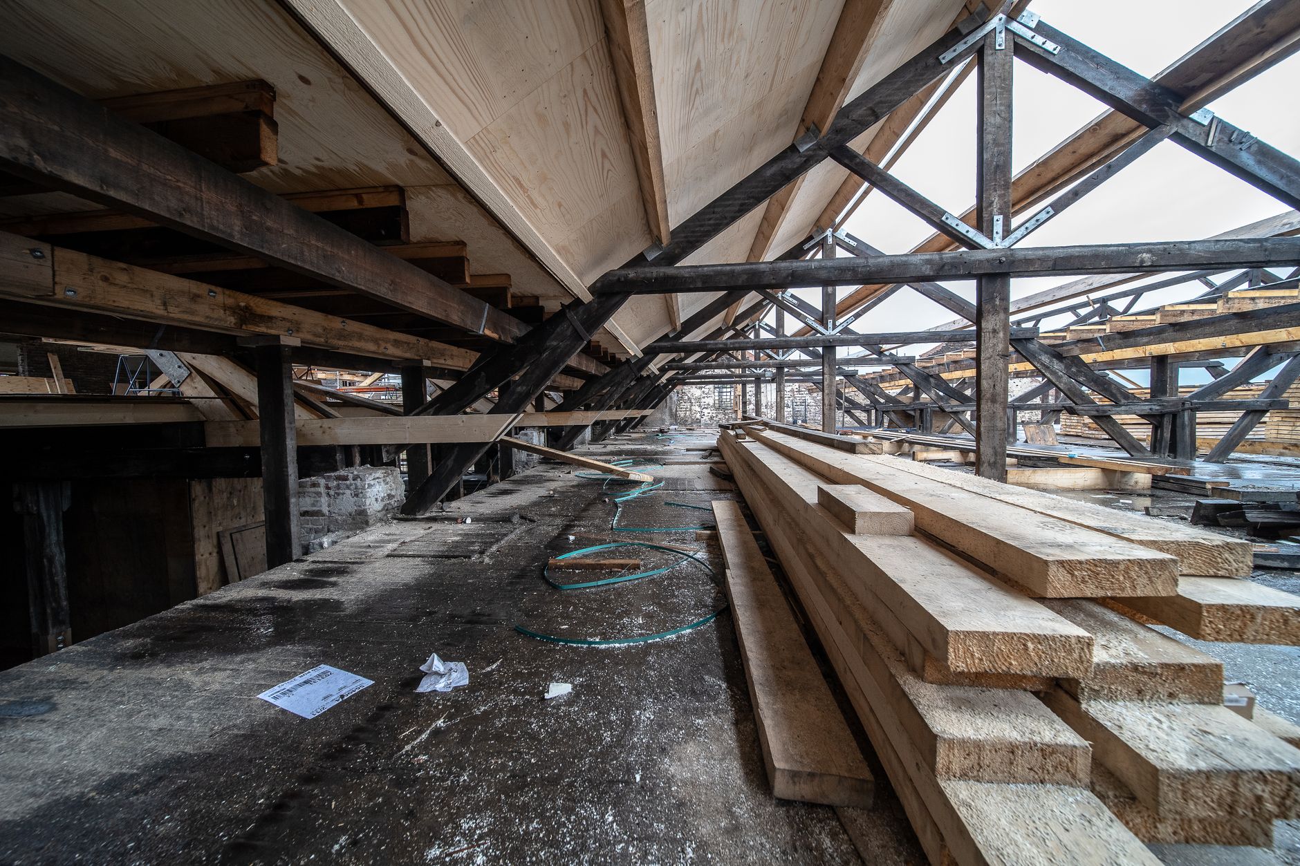 Detailed view of wooden beams in a loft under construction, showcasing structural design and materials