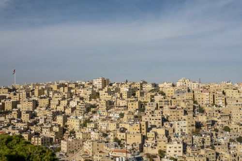 Free Explore the urban landscape of Amman from above, showcasing dense residential buildings and a clear sky. Stock Photo