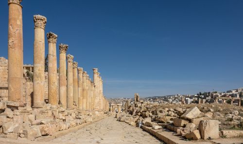Free Explore the historic Roman ruins of Jerash, showcasing ancient architecture under a clear blue sky. Stock Photo