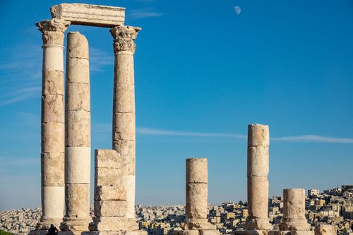 Free Explore ancient Roman ruins with iconic columns against a clear blue sky in this historic architectural scene. Stock Photo