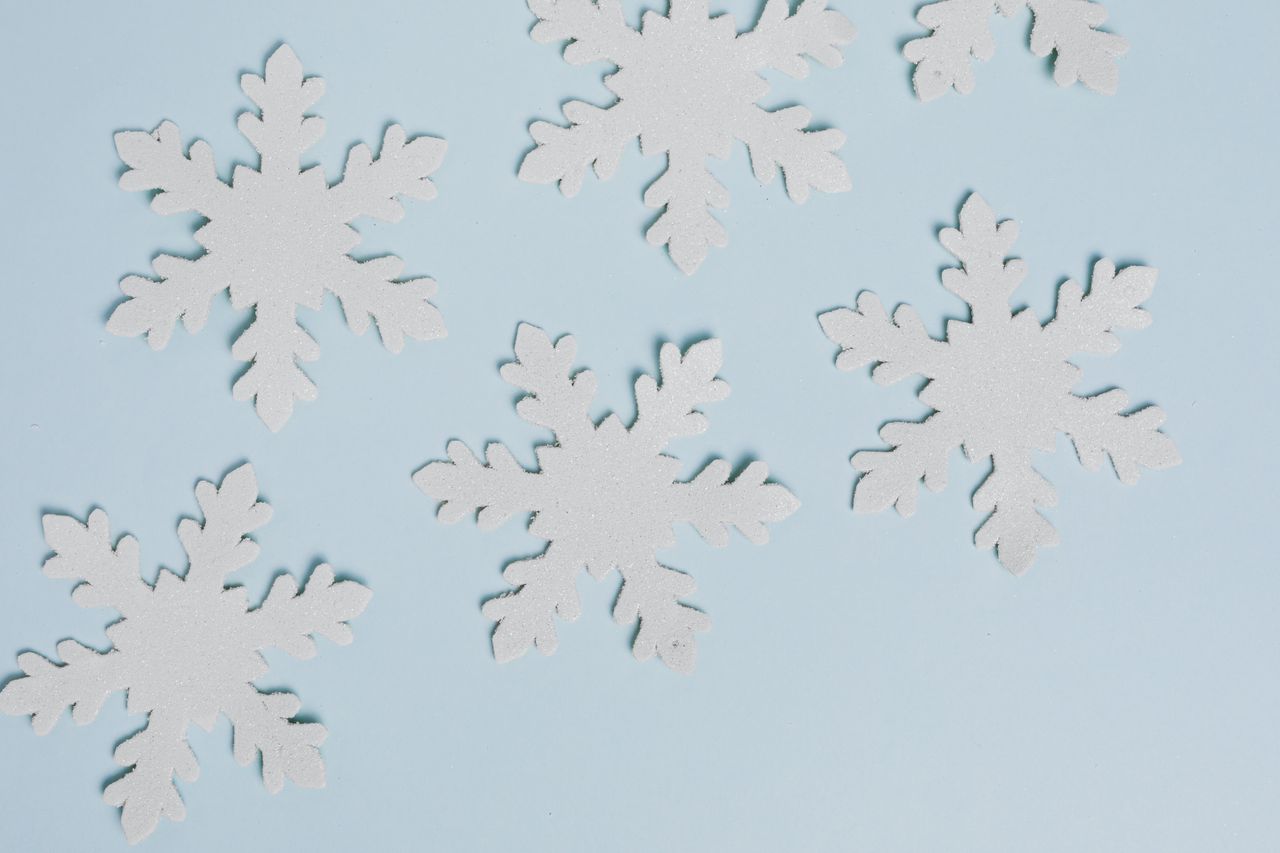 delicate white snowflakes arranged on a soft blue backdrop perfect for