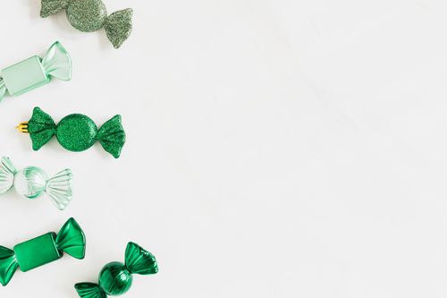 Free Green candy-shaped ornaments on a white background with ample copy space. Stock Photo