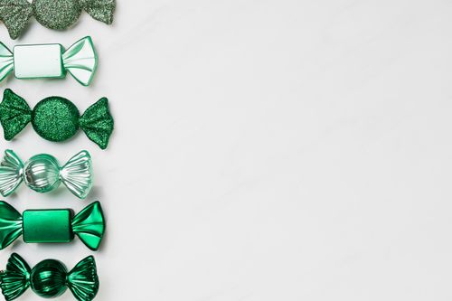 Free Elegant green candies arranged with ample copy space on a white background. Stock Photo