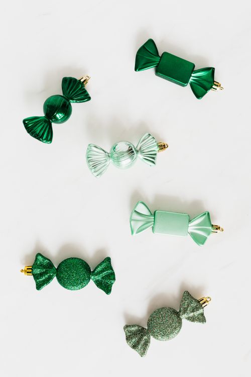 Free Shiny green decorative candies arranged on a white background. Stock Photo