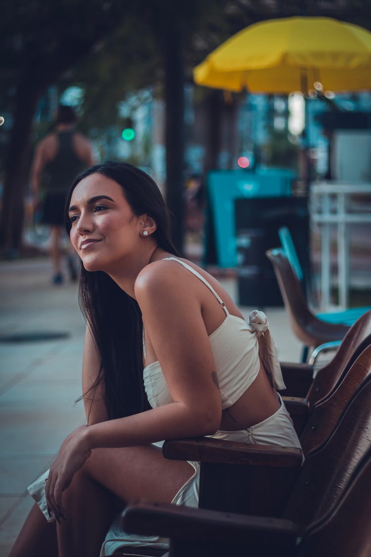 Positive Young Woman Chilling On Street At Night