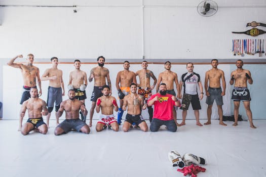 A group of male martial artists posing in a gym, showing strength and discipline.
