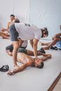 Men at Gym and a Coach Correcting a Pose 