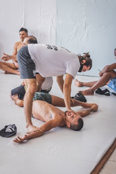 Instructor coaching a group in gym with focus on exercise and form correction.