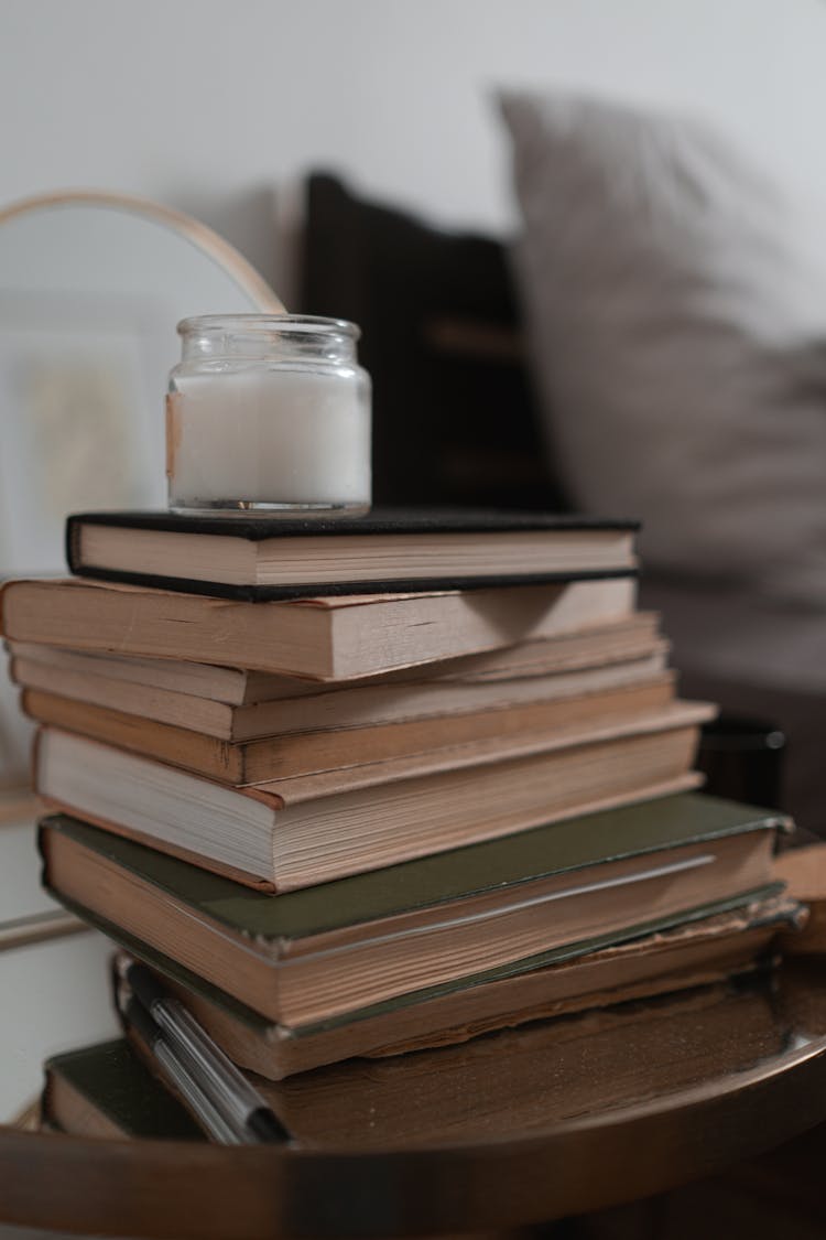 A Candle On A Stack Of Books