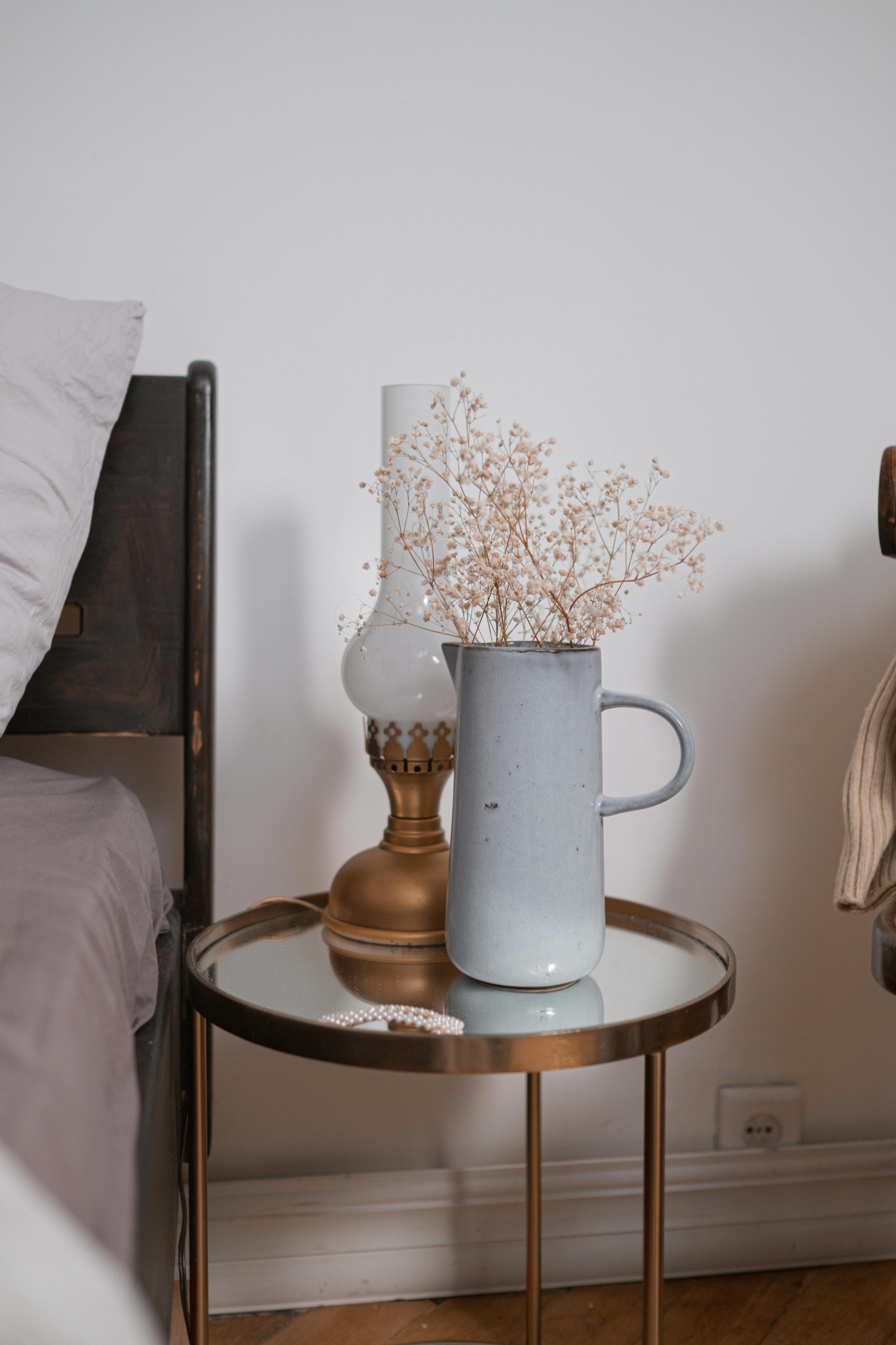 gray ceramic vase on glass round table top