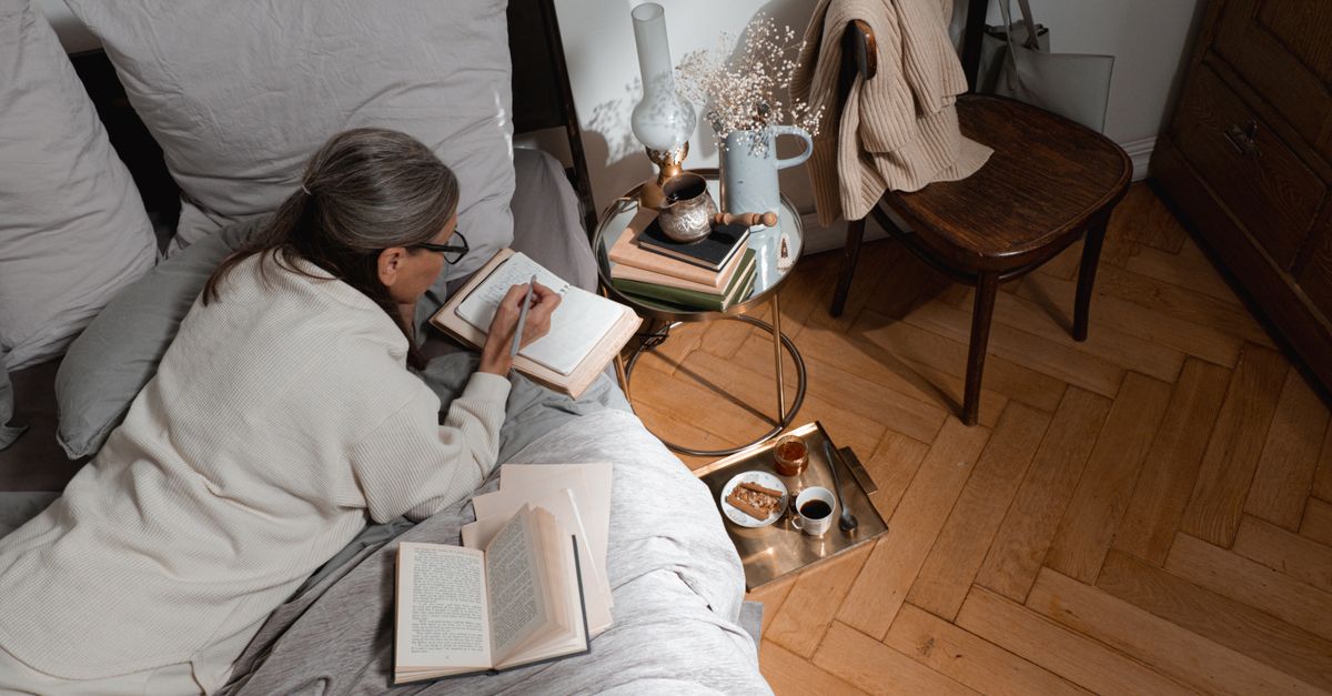 person journaling by window morning light coffee quiet devotional