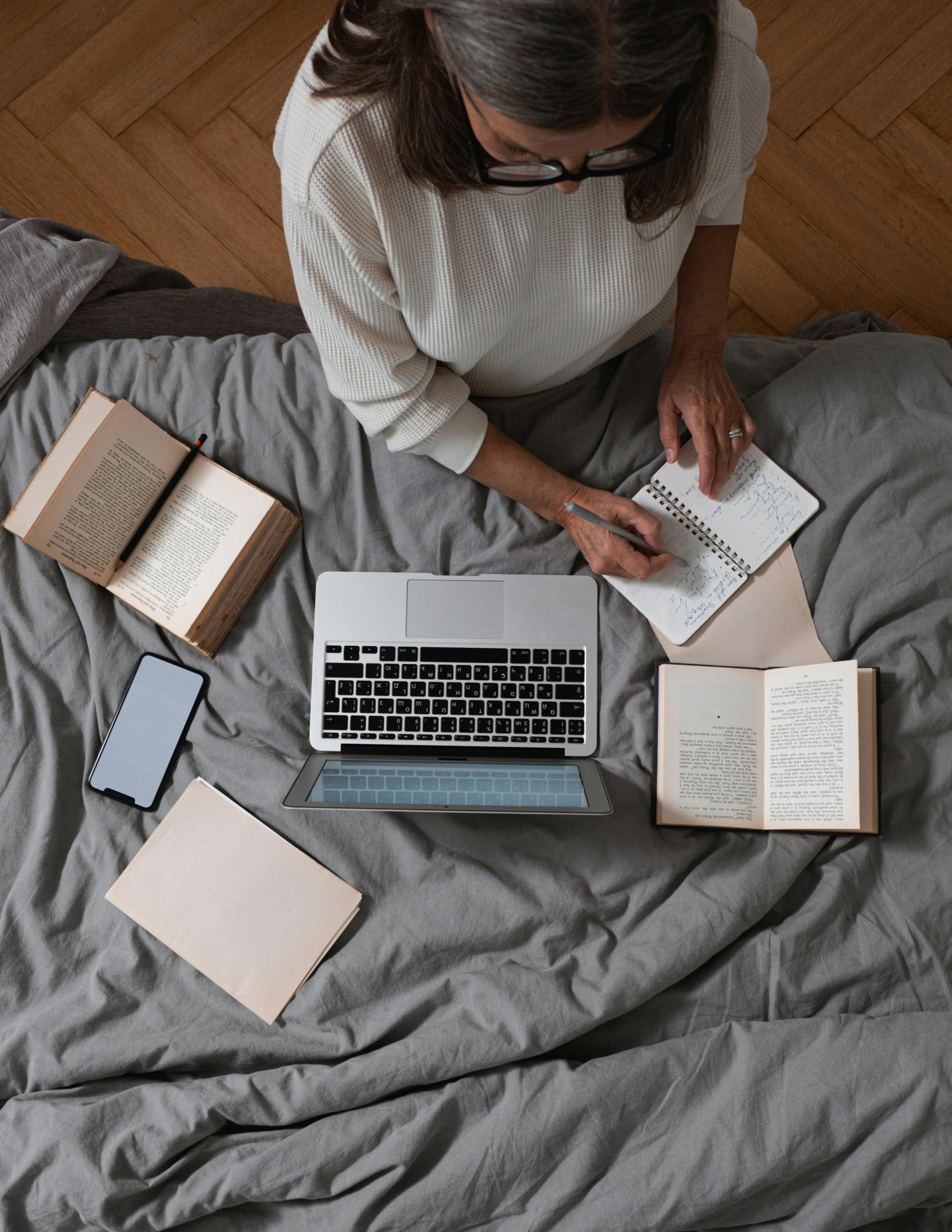 high angle shot of a woman taking notes