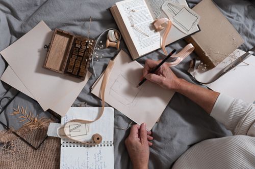 Sketchbooks and stamps flat lay — photo by cottonbro studio on Pexels