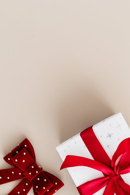 A Present and a Ribbon on a Beige Background