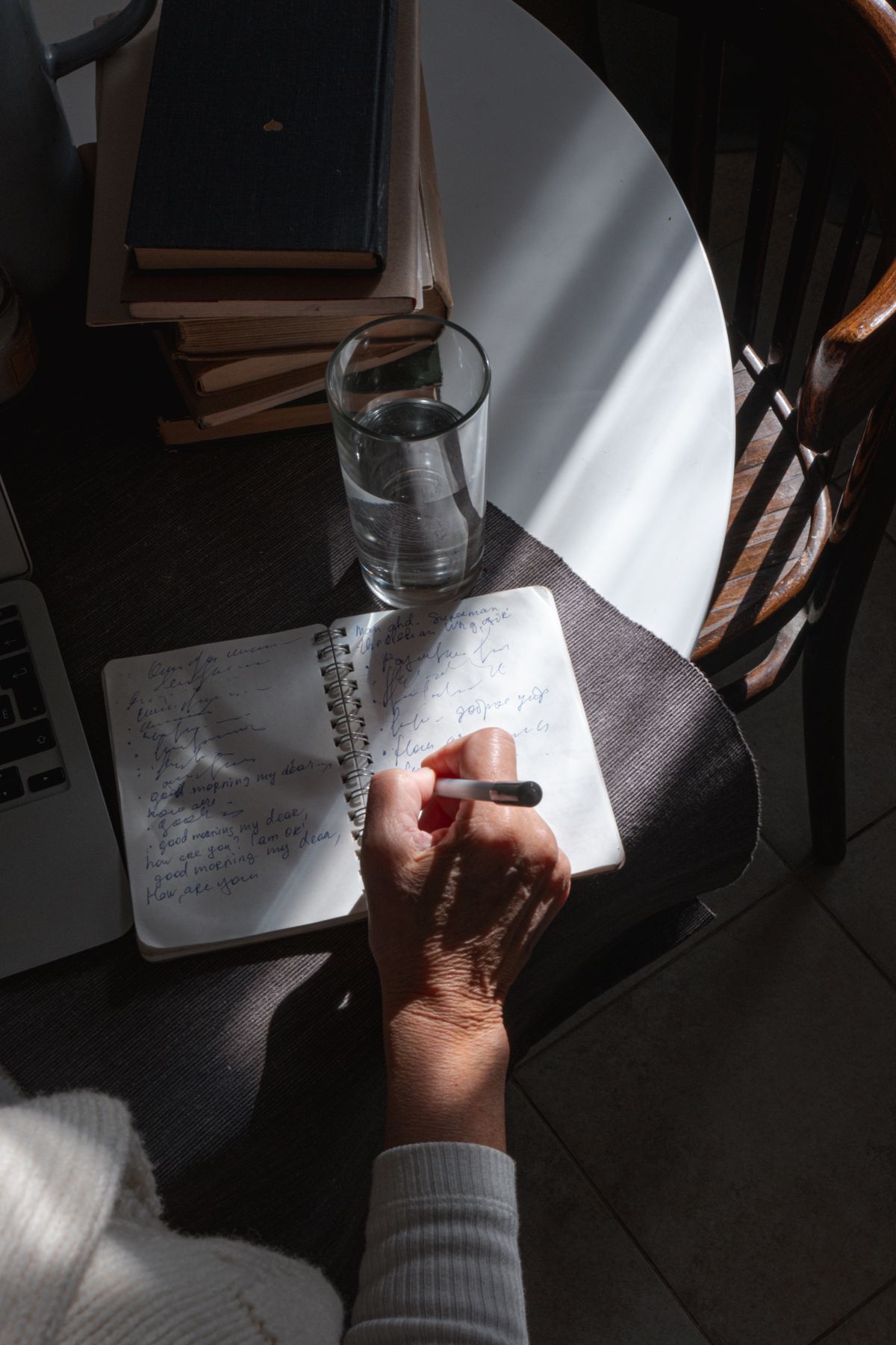 Person writing in a notebook with coffee — ChatGPT explained from zero