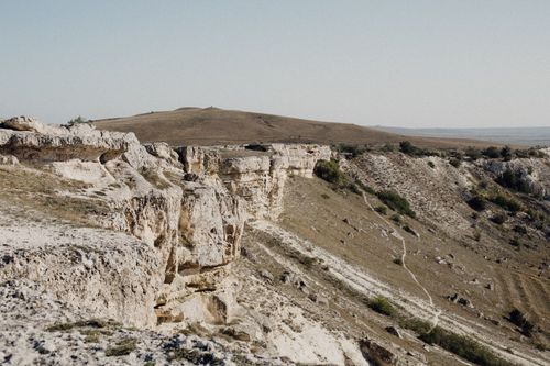Free A panoramic view of eroded hills and scenic landscape under clear skies. Stock Photo