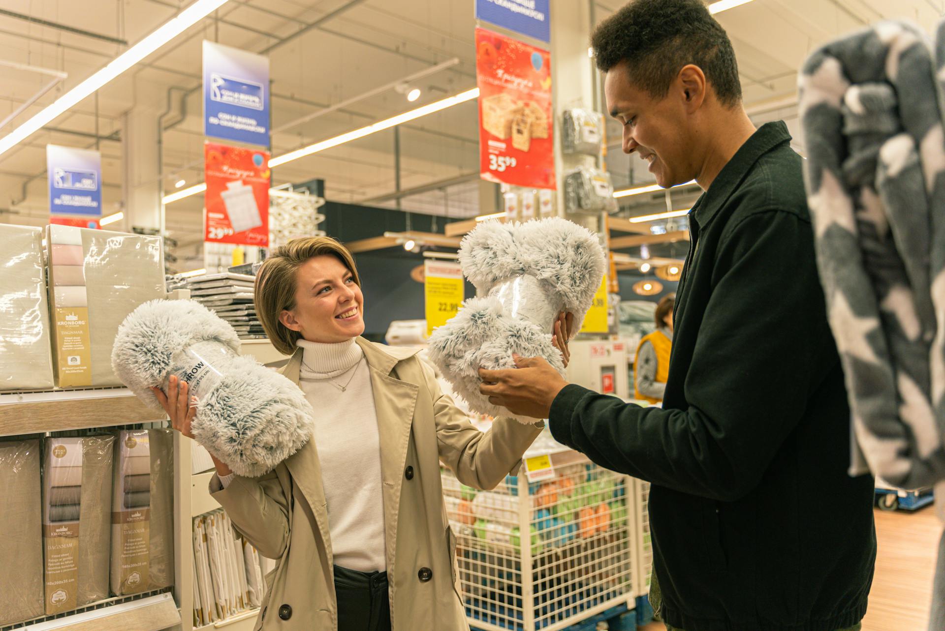 Man in Black Suit Jacket Holding Woman in White Coat