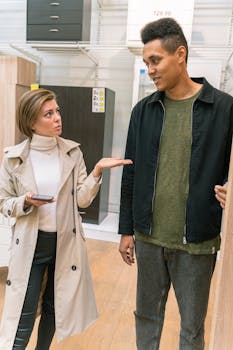 A woman and a man discussing furniture options in a retail store.