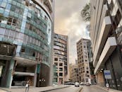 Buildings, Pedestrians and Cars on City Street