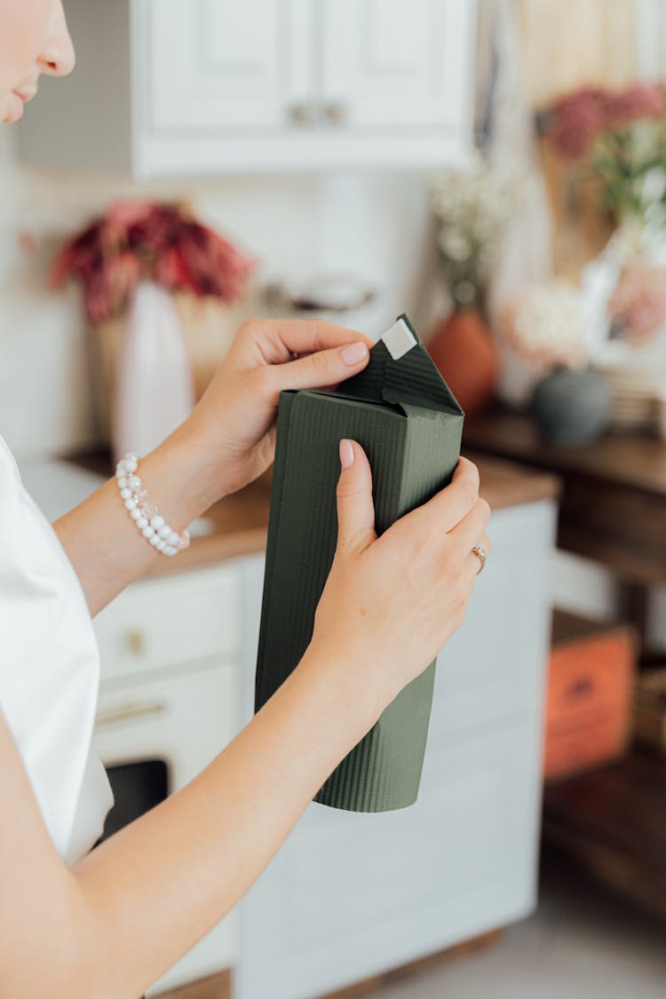 A Person Wrapping A Gift