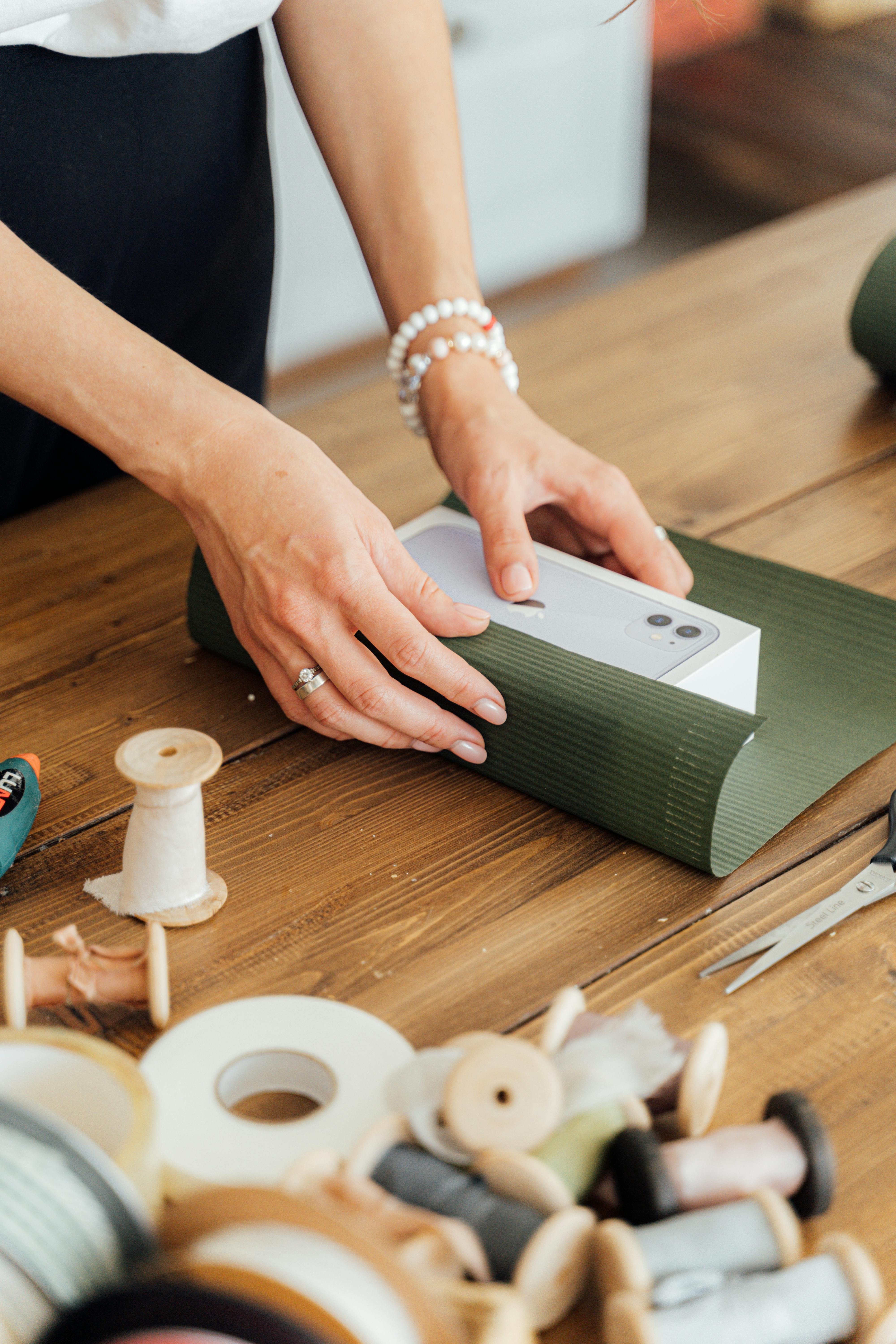 a person wrapping a gift