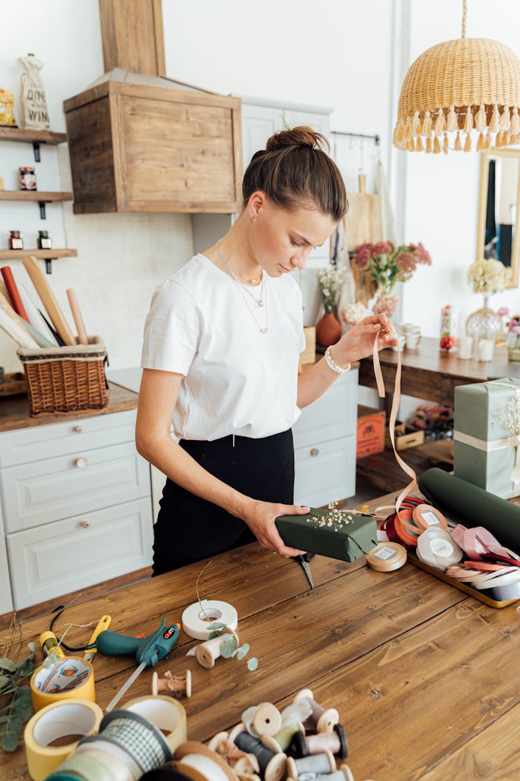 A Woman Wrapping A Gift