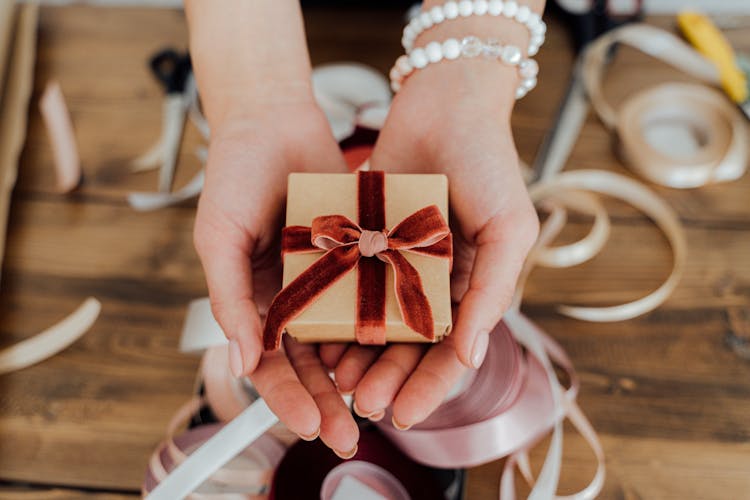 Person Holding A Small Gift Box