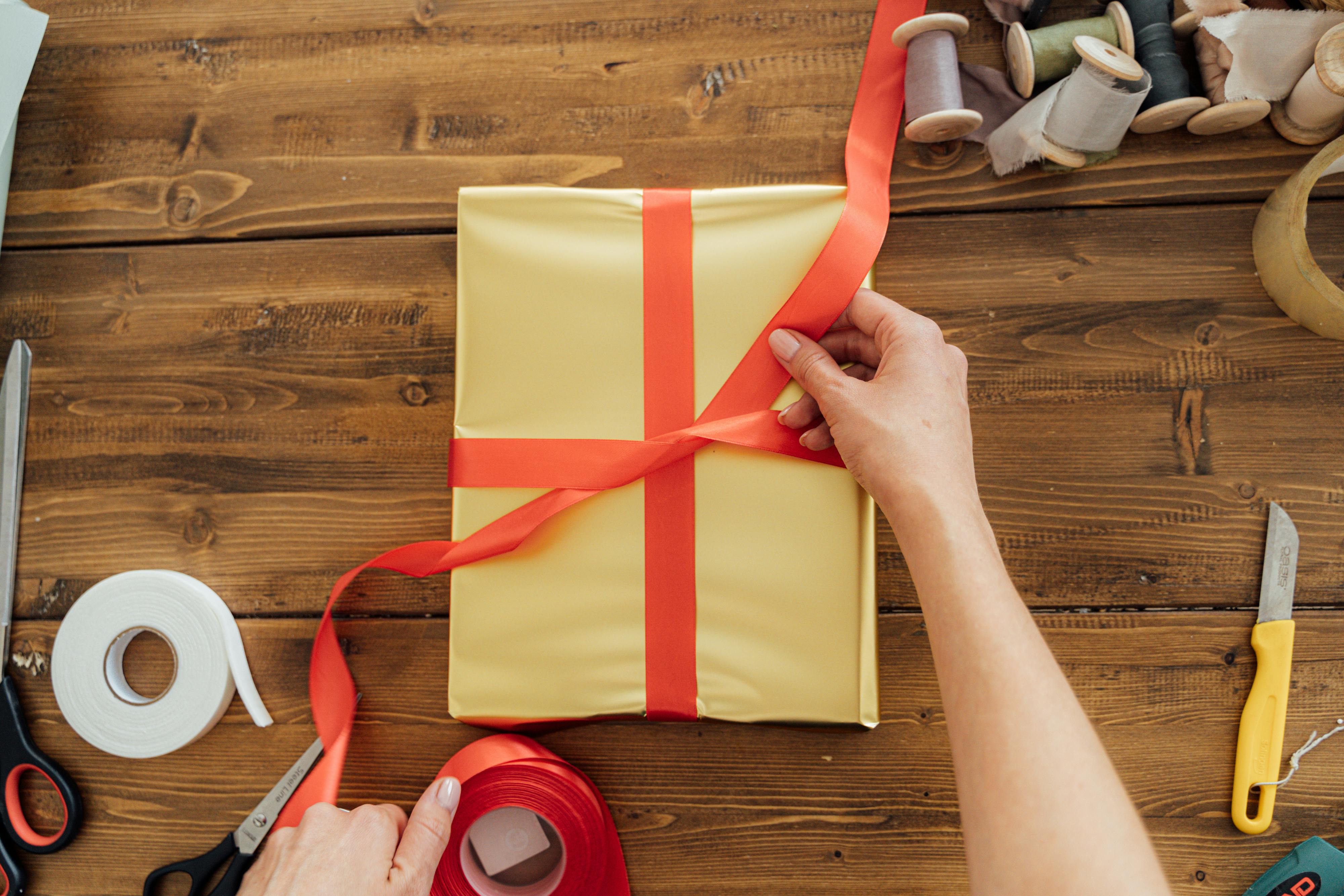 person holding yellow and red paper bag