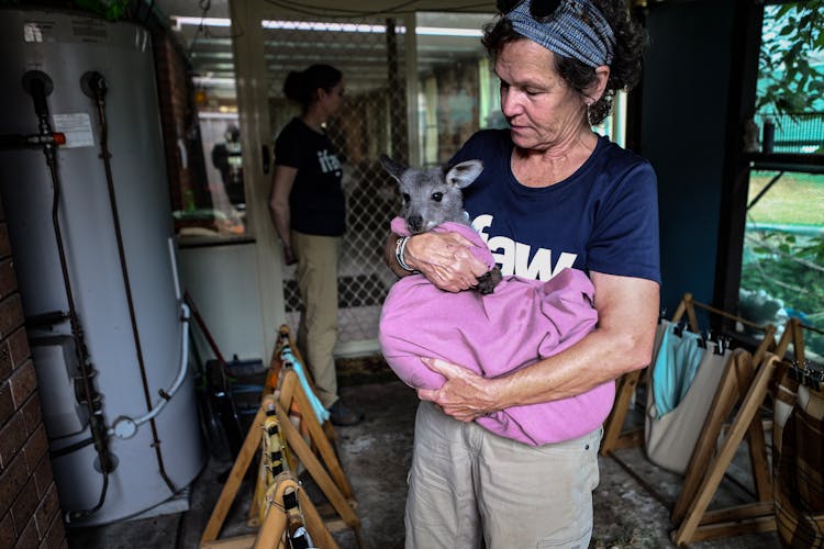 Woman Carrying A Baby Wallaby