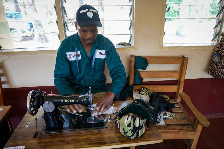 Man Making Face Masks With A Sewing Machine