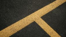 Asphalt road with bright yellow marking lines