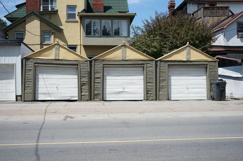 Row of residential garage doors on a sunny day