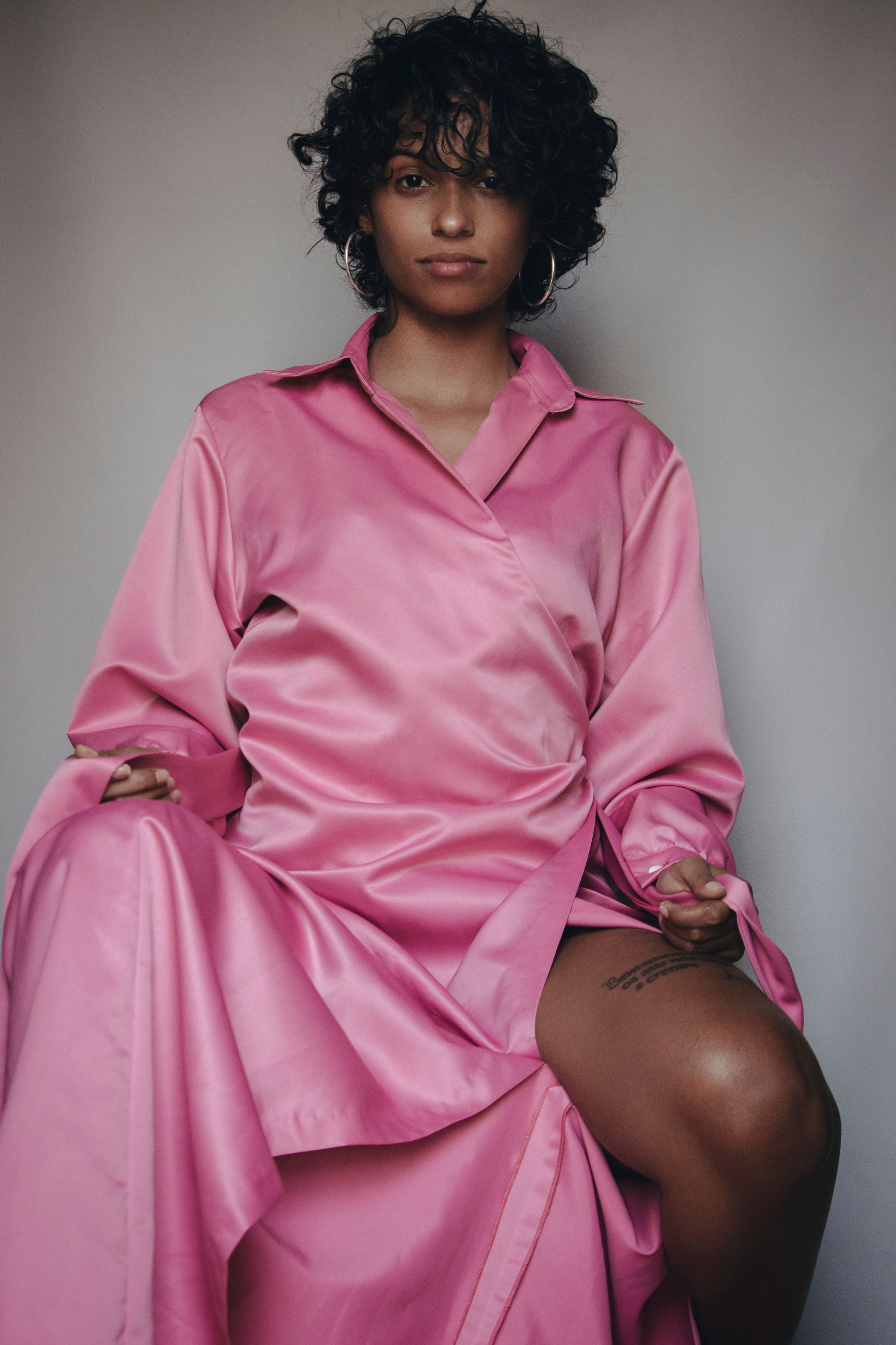 A Woman in Pink Dress Sitting while Posing · Free Stock Photo