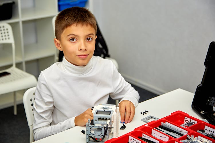 Close-Up Shot Of A Boy Playing Lego