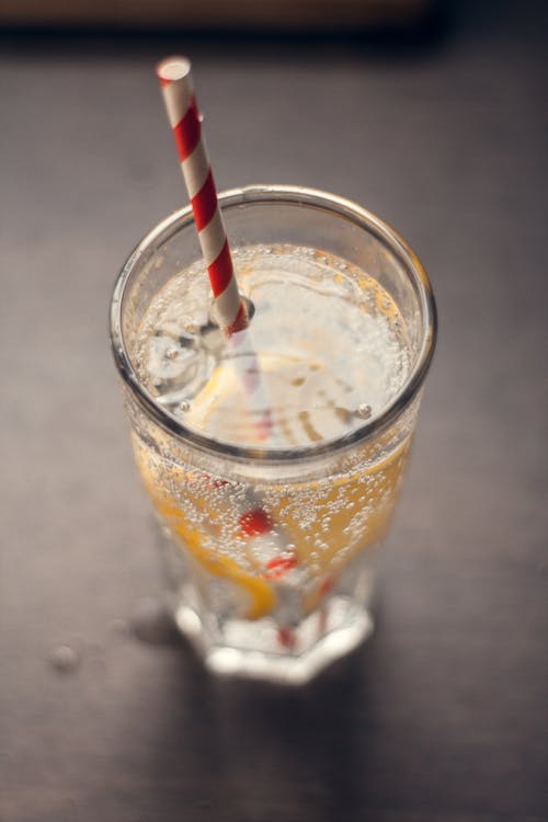 Free A Sparkling Drink in a Glass with a Drinking Straw Stock Photo