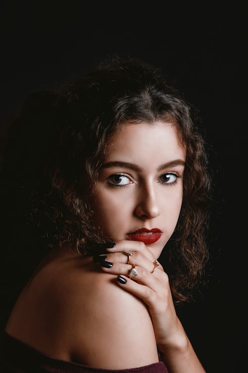 A Woman With Red Lipstick with Her Hand on Her Shoulder