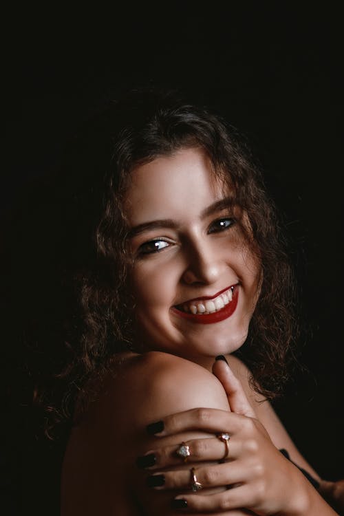 A Smiling Woman With Red Lipstick