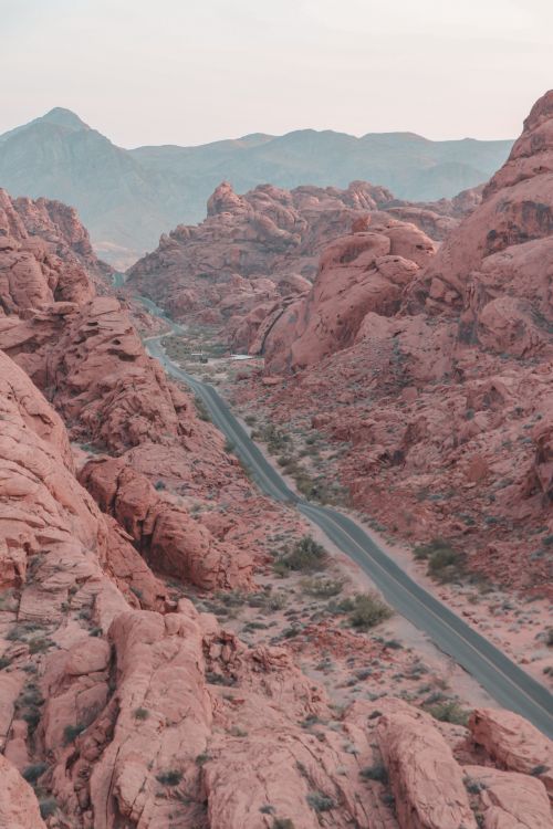 Free From above of narrow asphalt highway running between rocky formations in canyon in daylight in summer day in nature outside Stock Photo