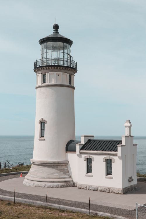 Free Iconic lighthouse on the Pacific coast in Ilwaco, Washington, under a clear sky. Stock Photo