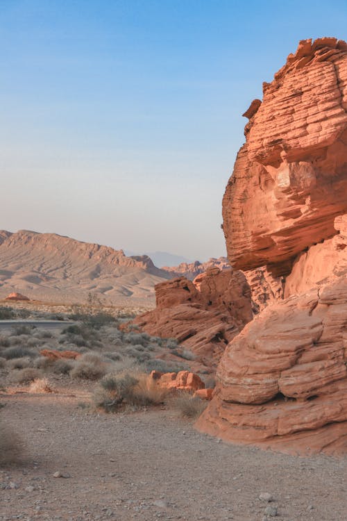 Canyon with huge rocky formations located on dry ground in semidesert against blue sky in daylight in nature in summer